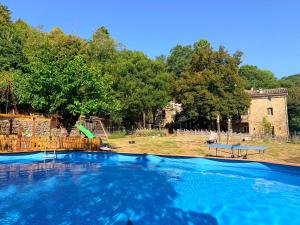 a large swimming pool in front of a house at Le Mas Sylva in La Barriére +13 photos