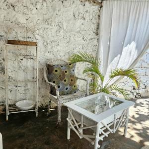 a living room with a white couch and a table at Palm Paradise in Diani Beach