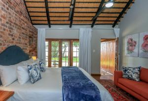 a bedroom with a bed and a brick wall at Crestwood Bed & Breakfast in Curryʼs Post +120 photos