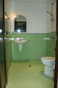 a bathroom with a sink and a toilet at Serenity Hotel in Sveti Vlas