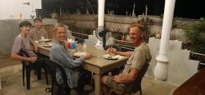 a group of men sitting at a table eating food at Kite Brothers Resort in Kalpitiya +26 photos