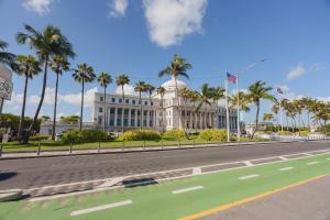 a building with palm trees in front of a street at The Oliver Hotel - Adults Only in San Juan
