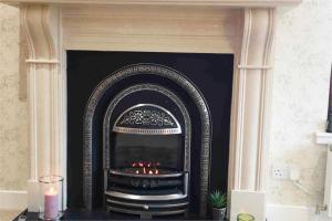 a fireplace in a living room with a fire place at The Little Beech Tree in Linlithgow