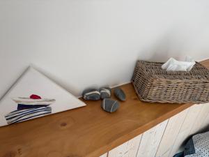 a table with shoes and a picture and a basket at Chambre d'hôtes les Galets Bleus in La Rochelle