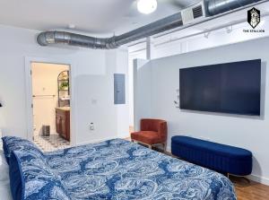 a bedroom with a bed and a flat screen tv at The Stallion in Memphis