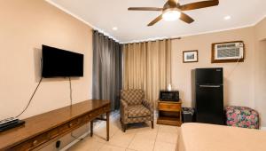a hotel room with a television and a desk with a chair at Copper Mountain Motel in Superior