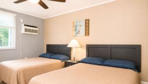 two beds sitting next to each other in a room at Copper Mountain Motel in Superior