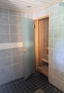 a bathroom with a door and a staircase in it at Axelin talo in Iitti +16 photos