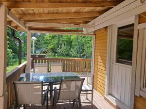 a patio with a table and chairs on a deck at Axelin talo in Iitti