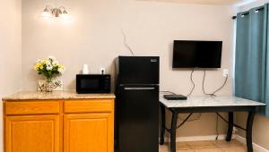 a kitchen with a black refrigerator next to a table at Copper Mountain Motel in Superior