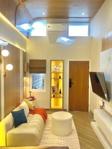 a living room with a couch and a tv at Willow House in Padalarang