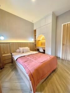 a bedroom with a large bed in a room at Willow House in Padalarang
