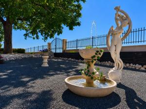 a fountain with a statue of two women on it at L'Expérience in Villermain