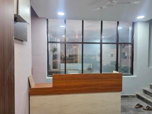 an office with a view of a large window at AJS Elite Rooms in Nagari