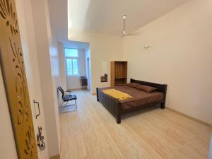 a bedroom with a bed and a chair in a room at AJS Elite Rooms in Nagari