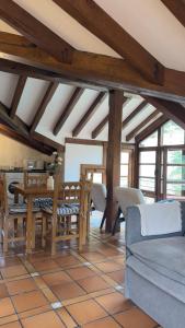 a living room with a table and chairs at Explora Picos de Europa in Cosgaya