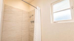 a bathroom with a shower with a shower curtain at Copper Mountain Motel in Superior +49 photos