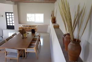 a dining room with a table and chairs and a vase at 6-Private Pool and View of Lake Chapala in Chapala