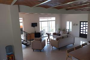 a living room with couches and chairs and a television at 6-Private Pool and View of Lake Chapala in Chapala