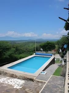 a swimming pool on the side of a building at 6-Private Pool and View of Lake Chapala in Chapala