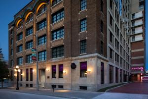 a large brick building on the corner of a street at New Moxy Ottawa Downtown in Ottawa