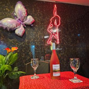 a bottle of wine on a table with two glasses at Trébol Hotel in Yurimaguas +27 photos