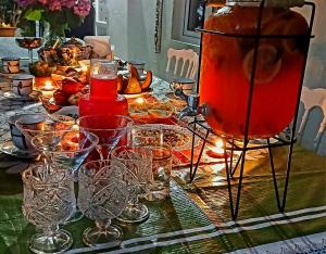a table with glasses and a pot on it at Grandmother Naziko in Vani