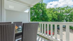 a patio with two chairs and a table on a balcony at Strandurlaub Baabe - Bade- & Saunawelt täglich inklusive in Baabe