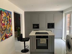 a kitchen with a stove top oven next to a painting at Ilsyn Grove in Brislington