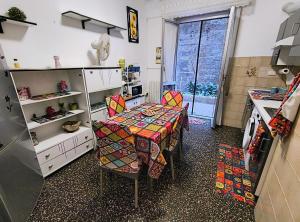 a kitchen with a table and chairs in a room at Pineta Holiday Home in Genoa +11 photos