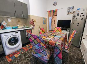 a kitchen with a table and a washing machine at Pineta Holiday Home in Genoa