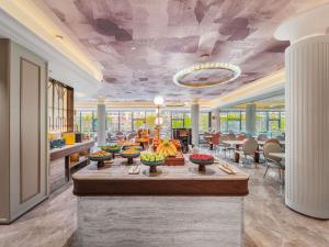 a lobby with a table with bananas on it at Mercure Qingdao May Fourth Square in Qingdao