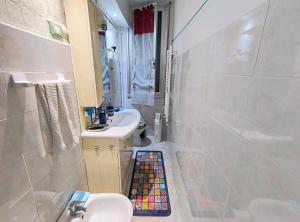 a bathroom with a sink and a toilet and a shower at Pineta Holiday Home in Genoa