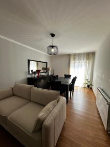 a living room with a couch and a dining room at Apartamento Jardim do Sol in Macedo de Cavaleiros