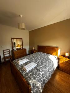 a bedroom with a bed with two towels on it at Apartamento Jardim do Sol in Macedo de Cavaleiros
