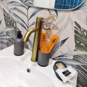 a bathroom sink with a bottle of soap and a soap dispenser at Gorgeous view apt riscanovca in Chişinău +17 photos
