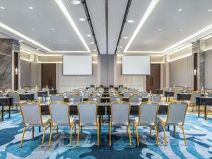 a conference room with a large table and chairs at Novotel Pontianak Convention Centre in Pontianak +73 photos