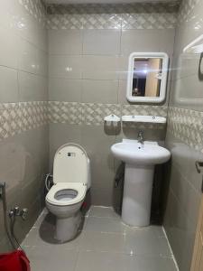a bathroom with a toilet and a sink at Nathigali A & M resort in Nathia Gali