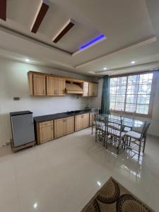 a kitchen and dining room with a table and chairs at Nathigali A & M resort in Nathia Gali
