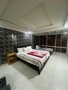 a bedroom with two beds in a room at Nathigali A & M resort in Nathia Gali