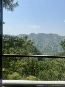 a view of a mountain view from a window at Nathigali A & M resort in Nathia Gali
