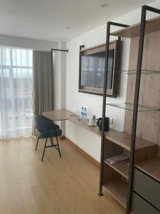 a room with a desk and a table and a chair at Landmark Hotel Nanyuki in Nanyuki