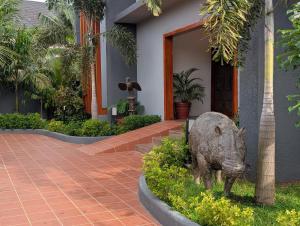 a statue of a pig in front of a house at Black Muse Residence in Benin City