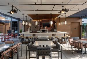 a restaurant with tables and chairs and a bar at Epicurean Atlanta, Autograph Collection in Atlanta