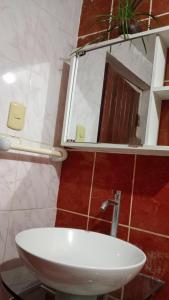 a bathroom with a white sink and a mirror at Jakcqueline in Pucallpa