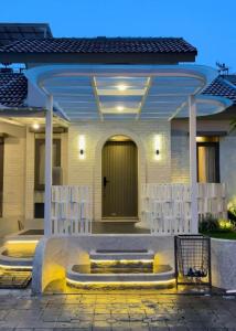 a house with a front porch with a door at Ivory House in Gantungan