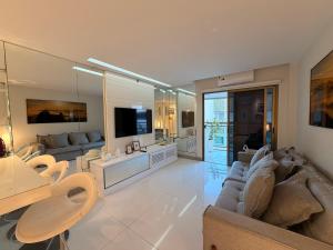 a living room with a couch and a television at MC FLATS IPANEMA BEACH STAR in Rio de Janeiro
