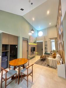 a kitchen and living room with a table and a couch at Ivory House in Gantungan