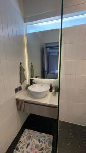 a bathroom with a white sink and a mirror at Ivory House in Gantungan