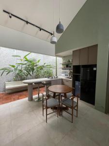 a kitchen with a table and chairs in a room at Ivory House in Gantungan +9 photos